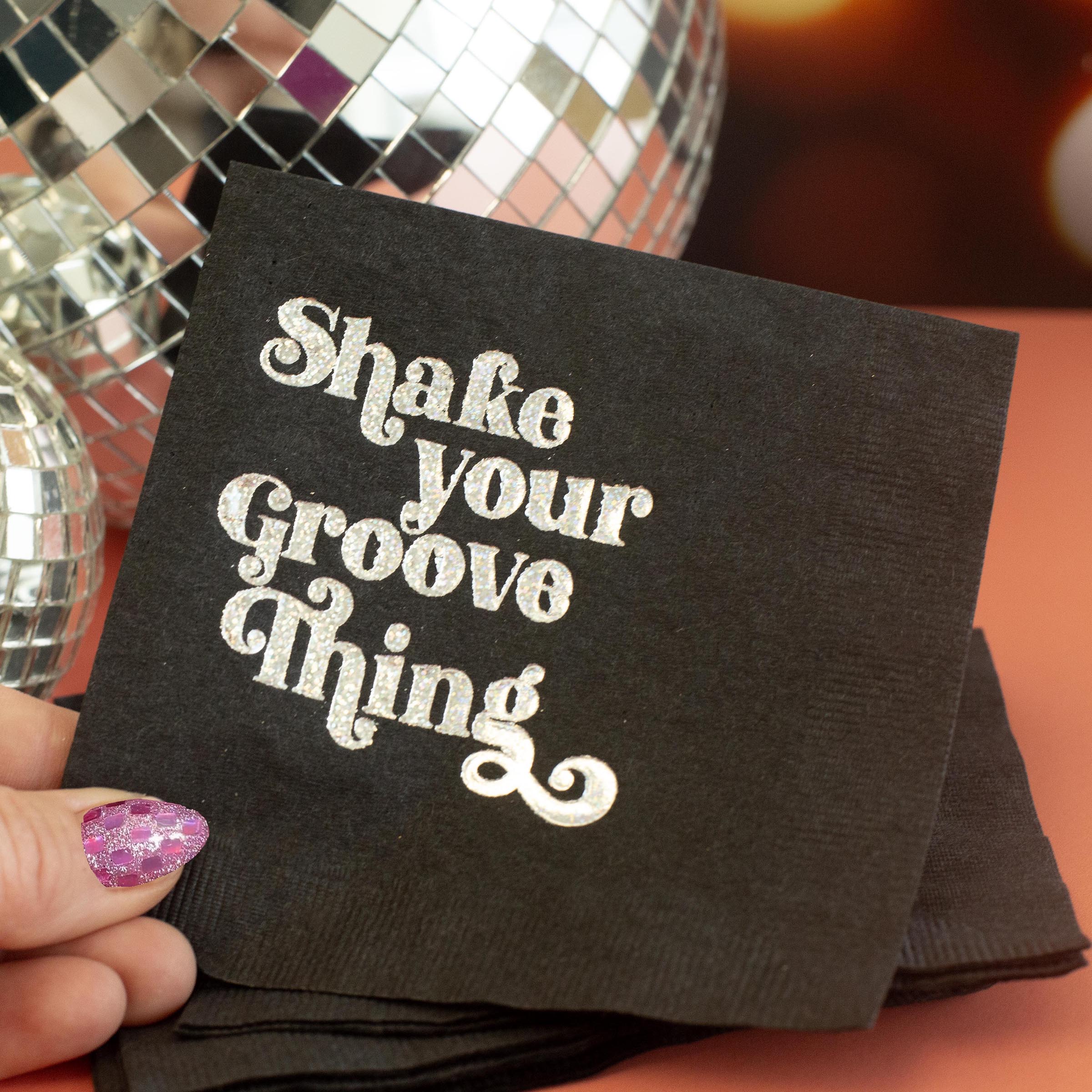 Get ready to shake things up with our Shake Your Groove Thing Silver Glitter Foil Cocktail Beverage Napkin! Set of 20 boxed napkins makes it perfect for gift giving or convenient storage. Add a touch of shimmer and style to any 70's disco theme party or event. Let your guests groove and enjoy their drinks in style with these sparkling, high-quality napkins.