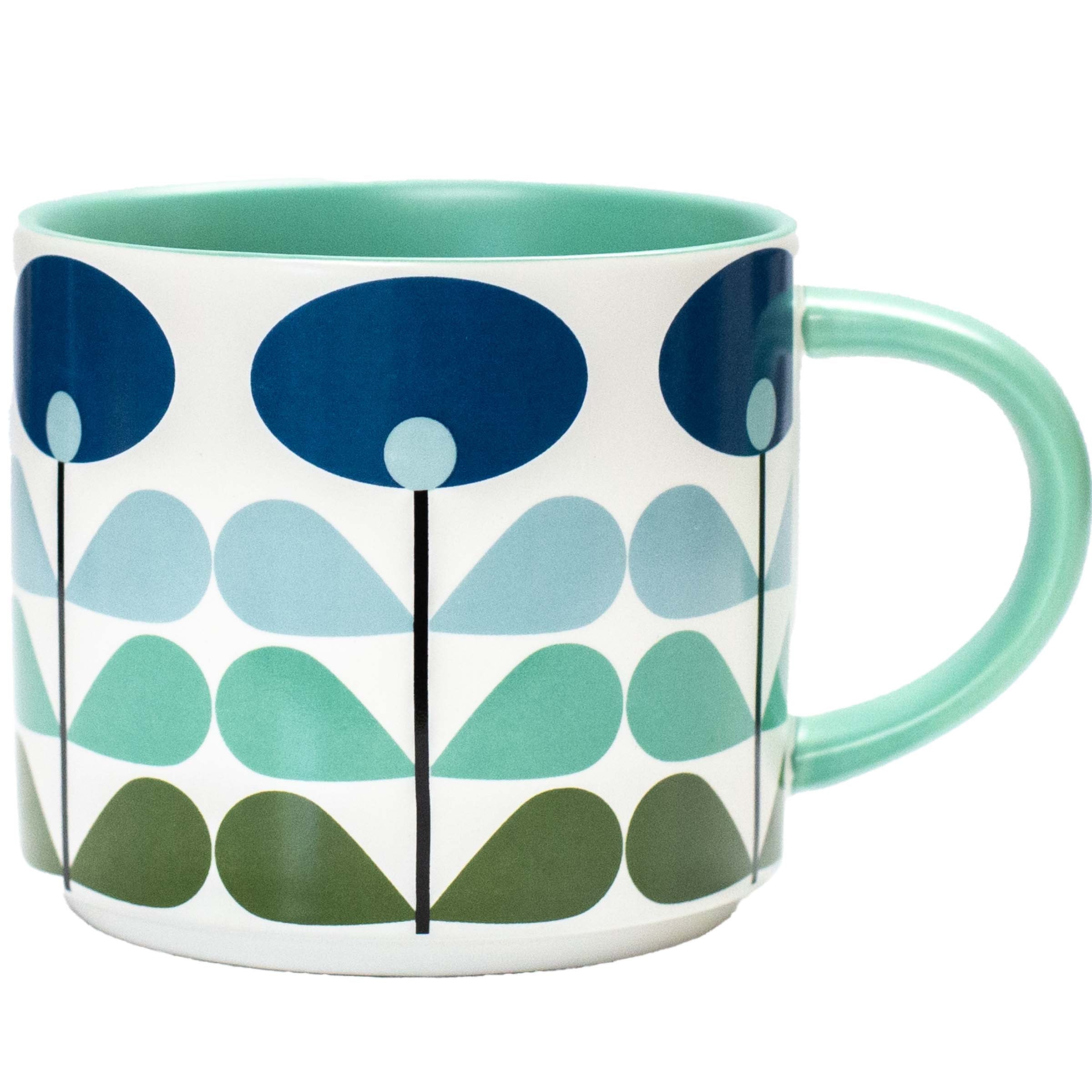 A white ceramic mug featuring a retro mid-century modern floral pattern in shades of blue, teal, and green, with a mint green interior and handle.