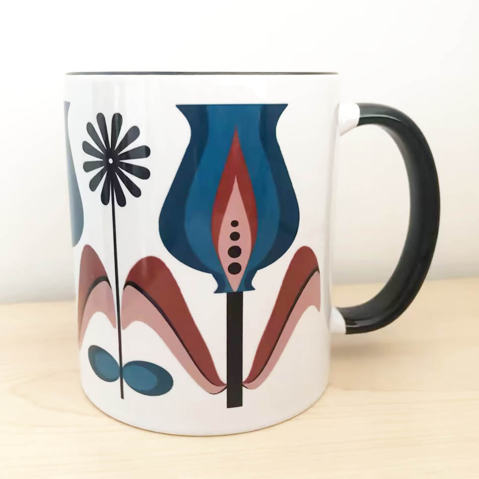 Enjoy your morning coffee in vintage style with our Bulb Tulip Mid Century Modern Flower Coffee Mug! An 11oz mug featuring a classic retro tulip design, this mug is the perfect way to infuse your day with mid-century modern charm. The contrast handle and inside make it eye-catching, while the ceramic stoneware material ensures its long-lasting quality. Start your day with sophisticated style!