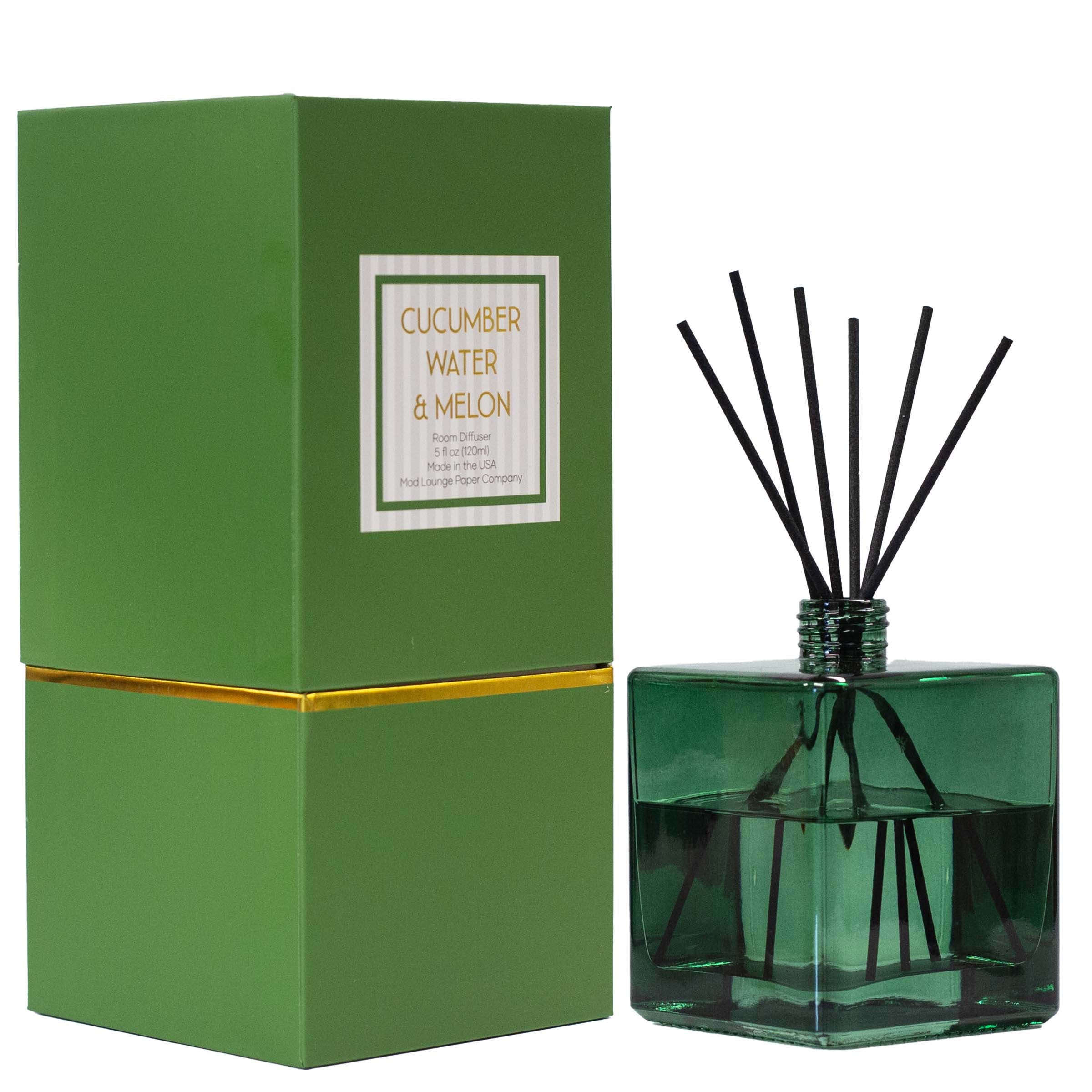 A reed diffuser bottle in translucent green glass with black reeds, shown next to its green box labeled 'Cucumber Water & Melon' on a white background.