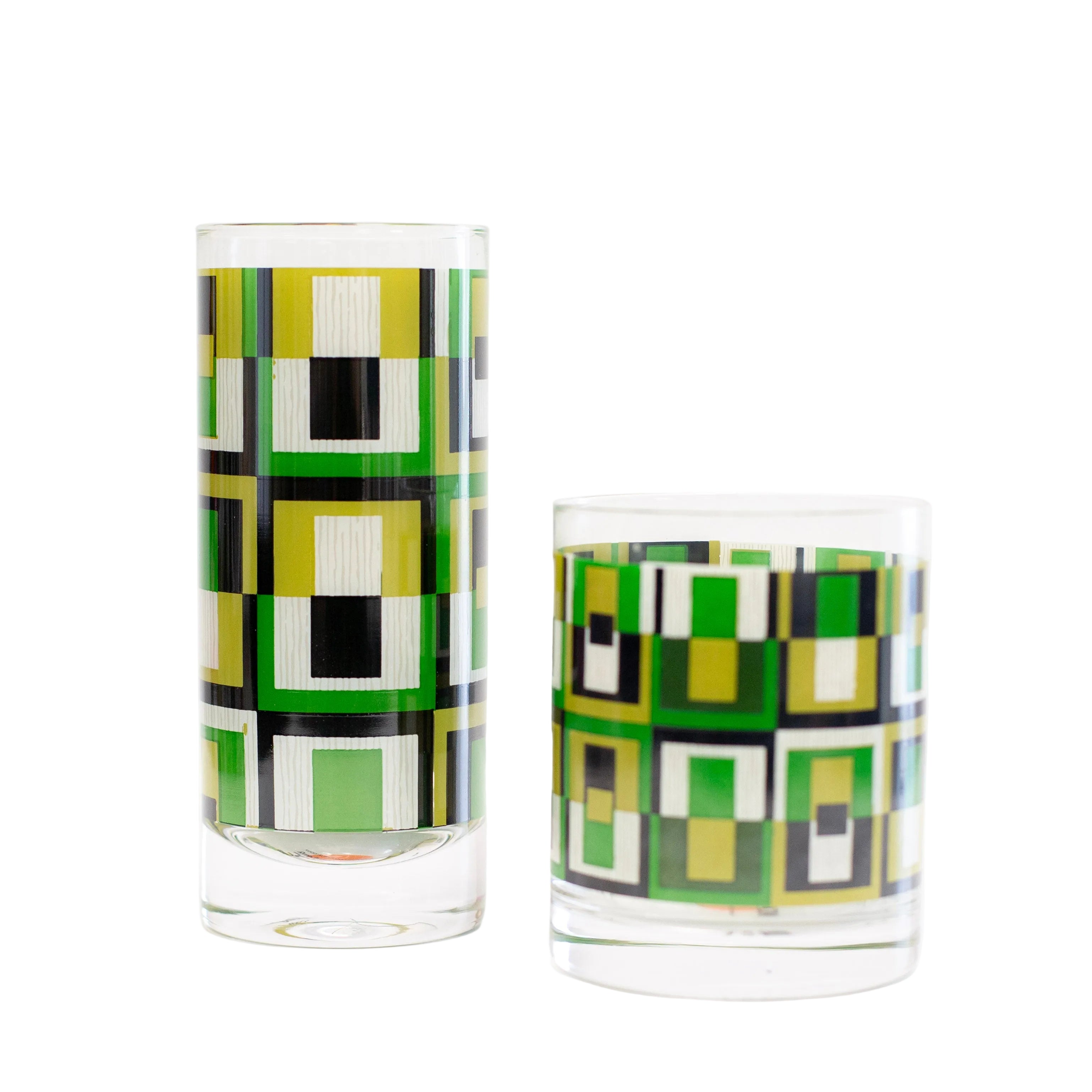 Two glass tumblers with geometric green and black pattern on a white background