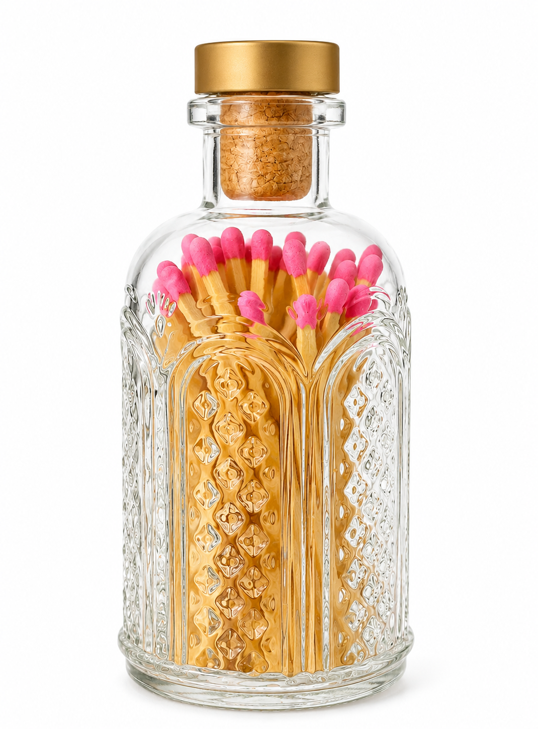 Hot pink-tipped wooden matches in an ornate clear glass jar with a gold-topped cork stopper