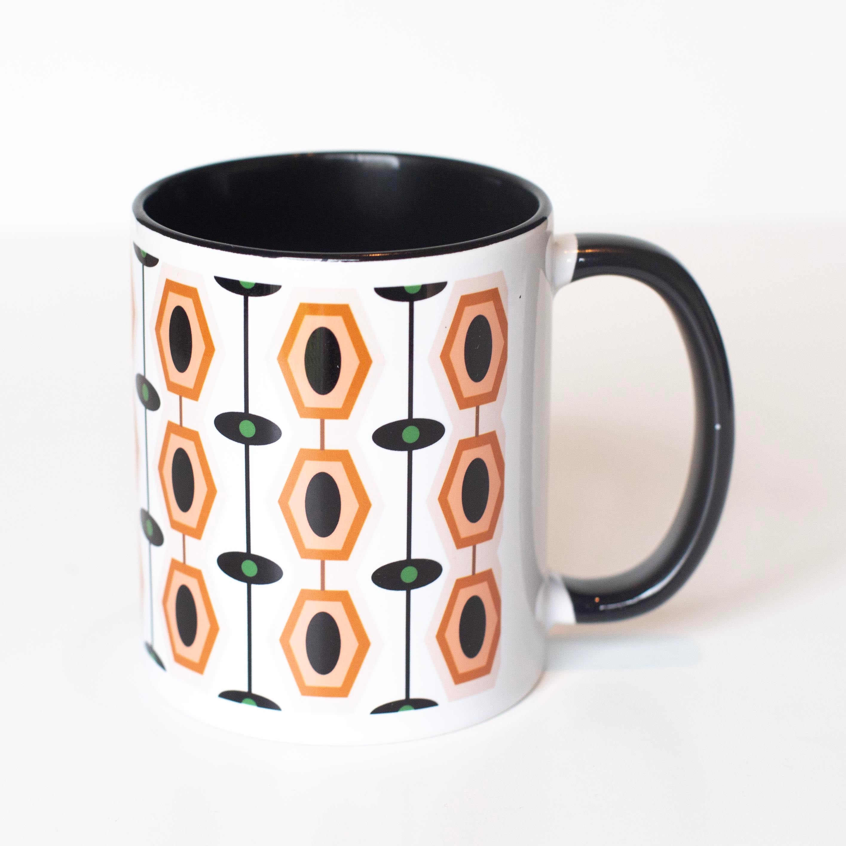 This classic ceramic mug is perfect for the modern coffee enthusiast. Its mid-century modern aesthetic, geometric hexagon pattern, and neutral brown color palette make it a timeless addition to any kitchen. With its 11 oz capacity and&nbsp;contrasting&nbsp;handle, you can sip your morning brew in style! So why not enjoy your morning cup with a touch of modern sophistication?