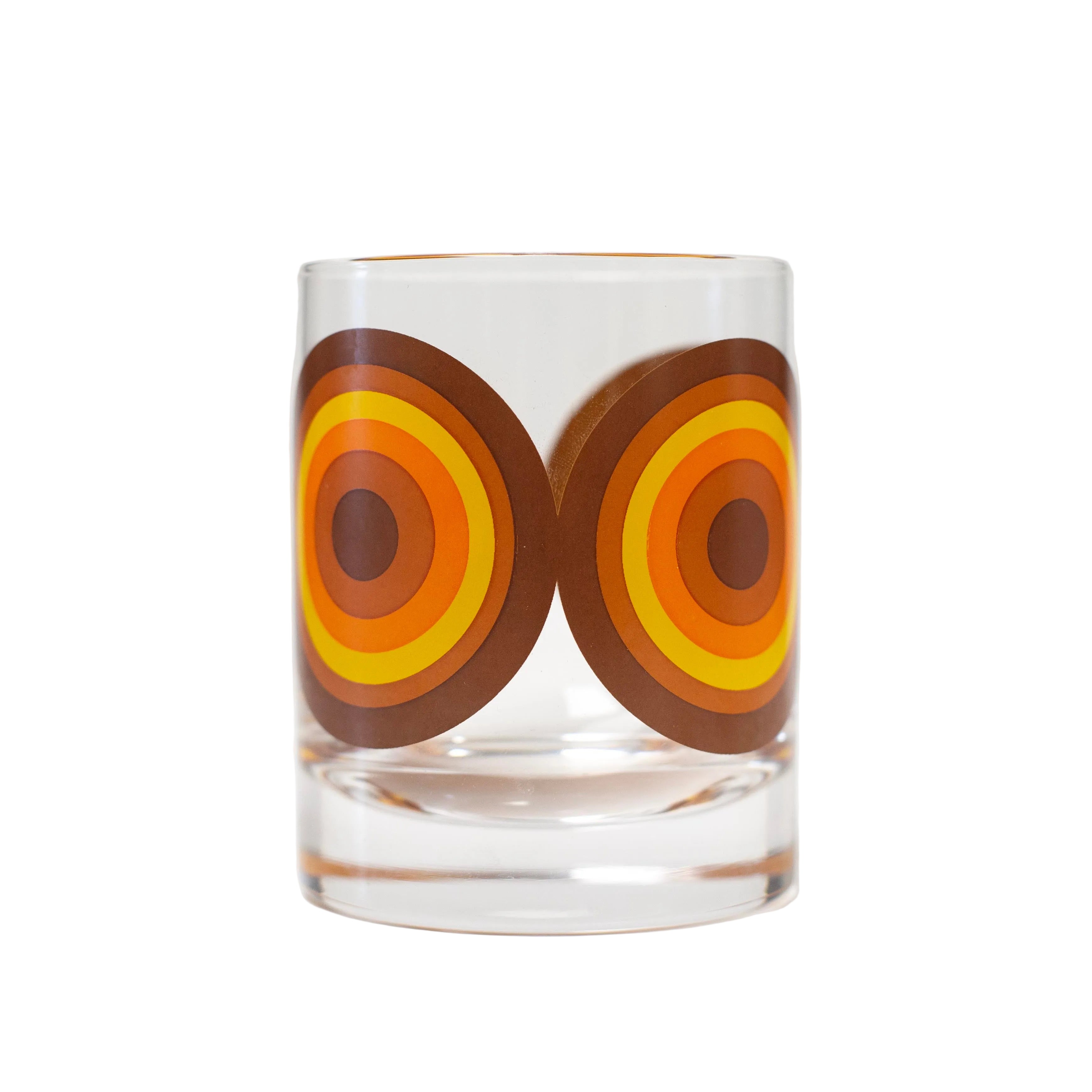 Clear glass with brown and orange circular design on a white background