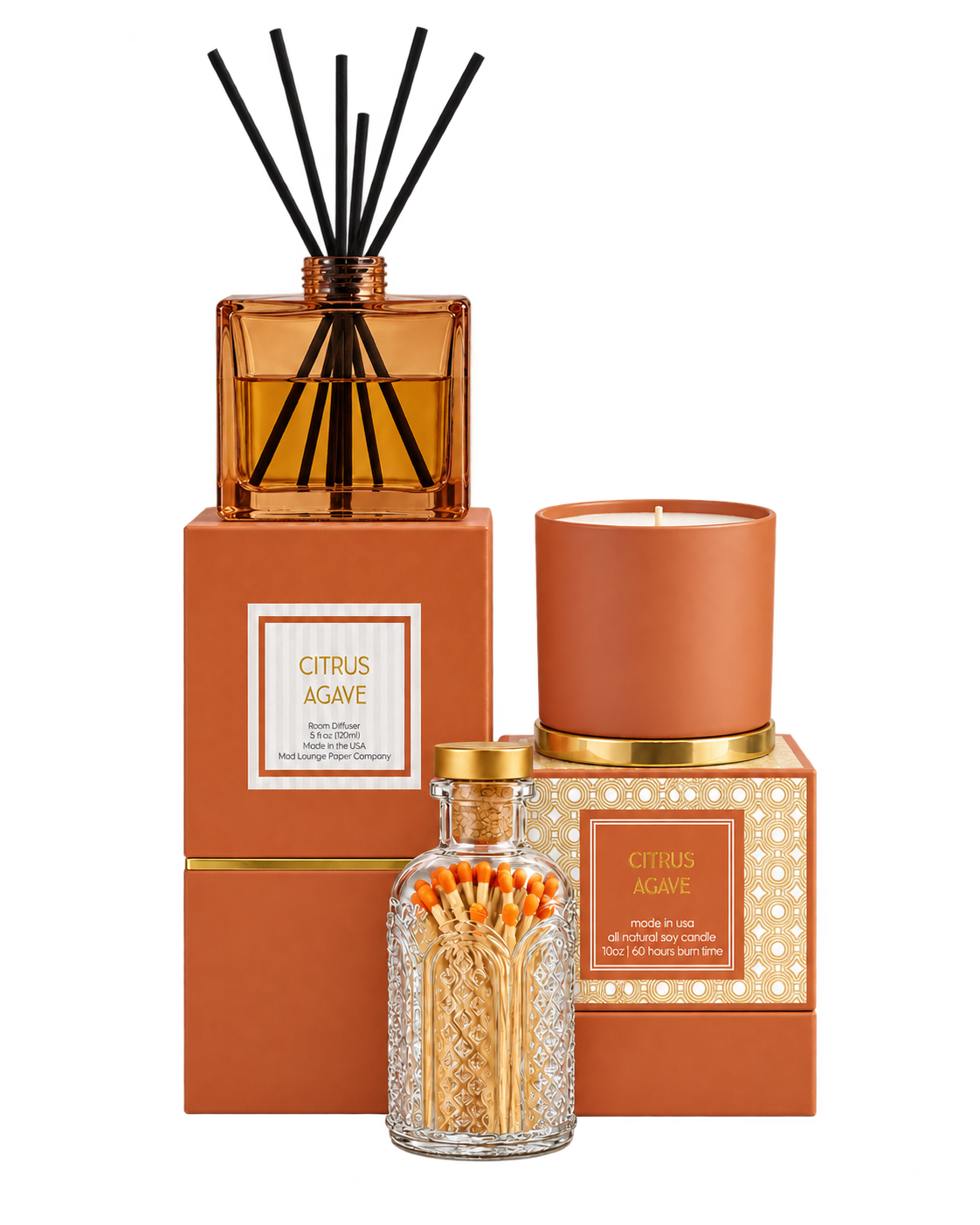 A reed diffuser and candle gift set in a citrus agave scent, featuring an amber glass reed diffuser bottle with black reeds, a terracotta candle, a glass bottle of matches, and matching orange-brown boxes with gold accents on a white background.